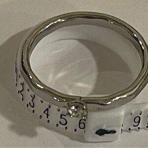 Silver toned hammered clear stone ring